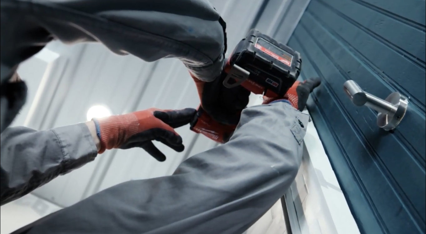 shot from below worker installing bathroom item